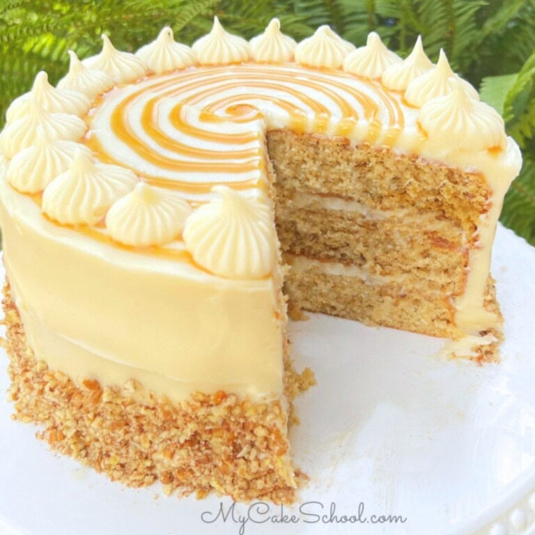 Caramel Italian Cream Cake, sliced, on a cake plate.