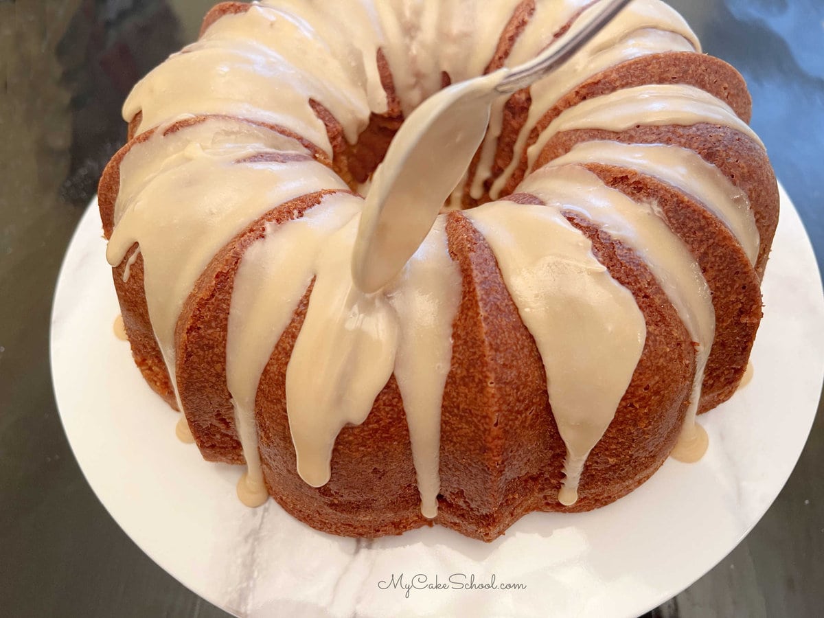 Applying the Caramel Icing Glaze with a spoon