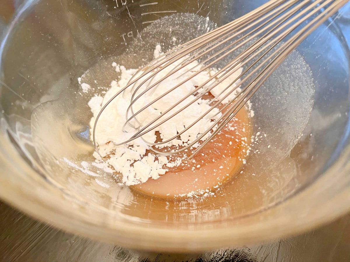 Mixing powdered sugar into caramel mixture