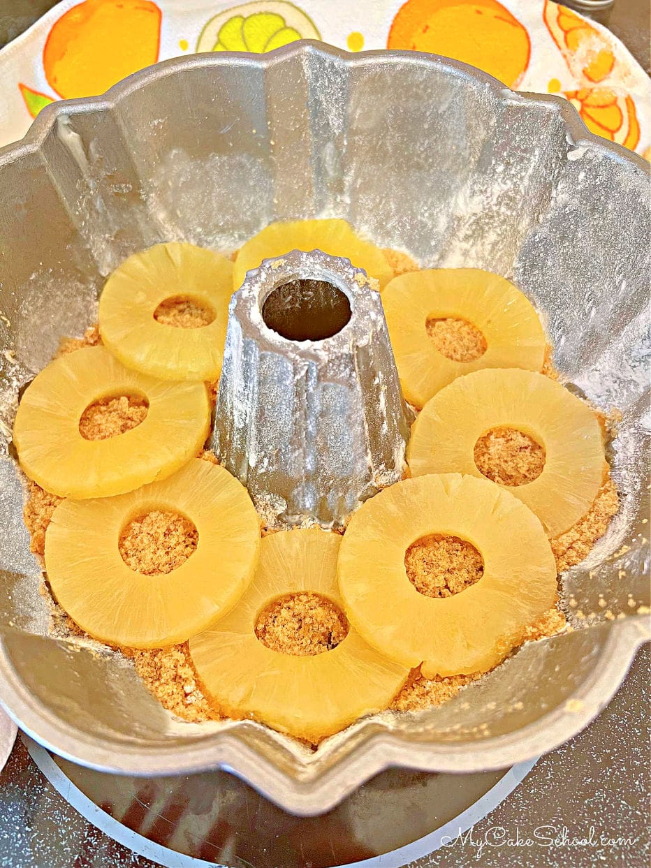 Pineapple Rings on top of brown sugar at the bottom of bundt pan