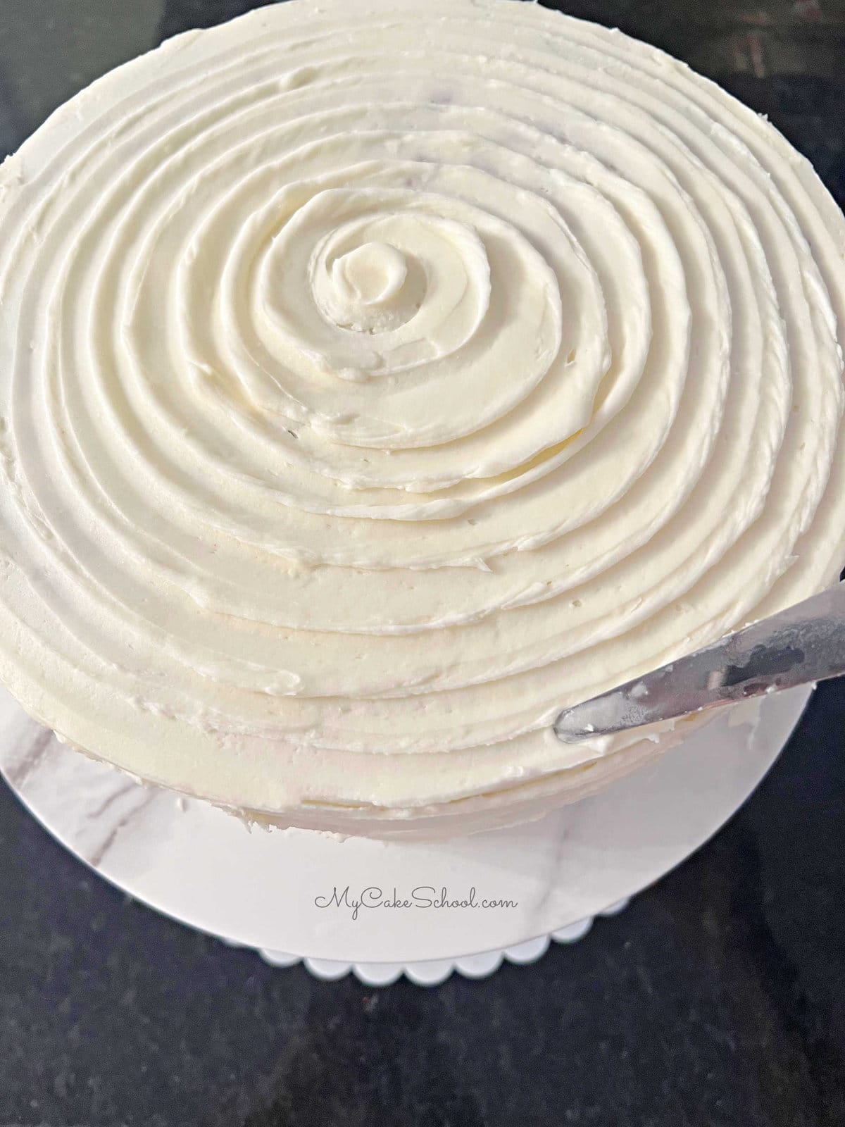 Adding a spiral on top of the cake with an offset spatula