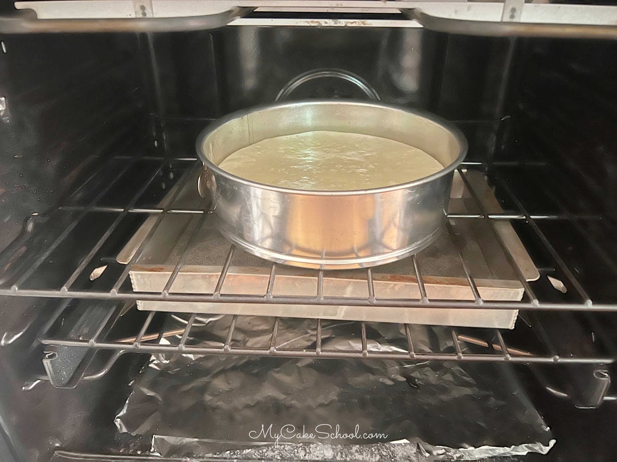 Cheesecake baking over a sheet cake pan partially filled with water