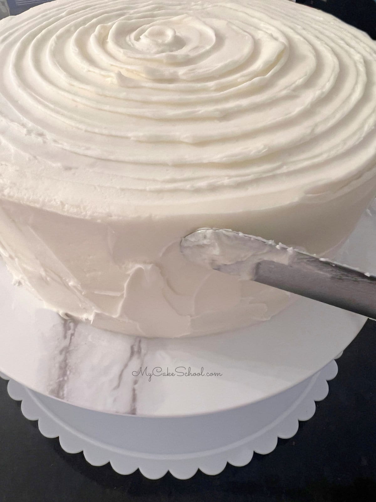 Adding texture to the cake frosting with an offset spatula
