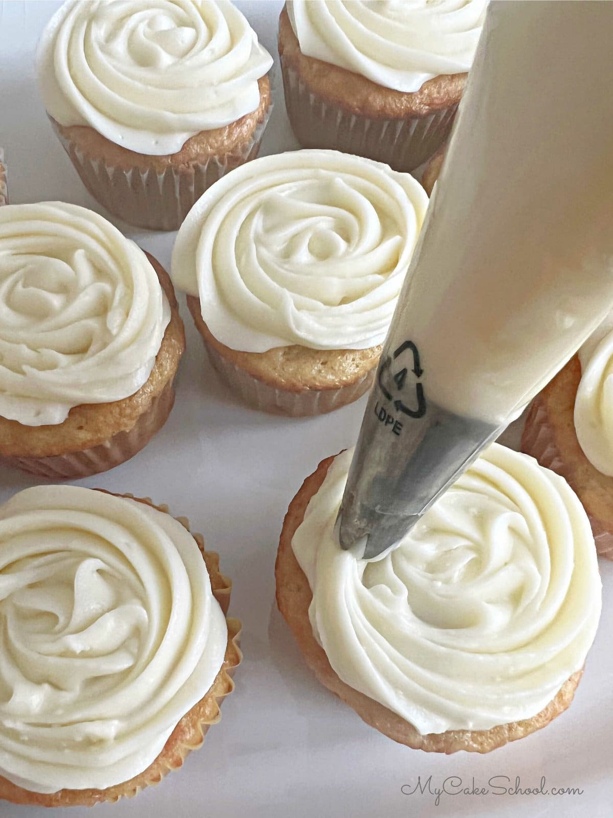 Frosting Cupcakes with swirls of Cream Cheese Frosting