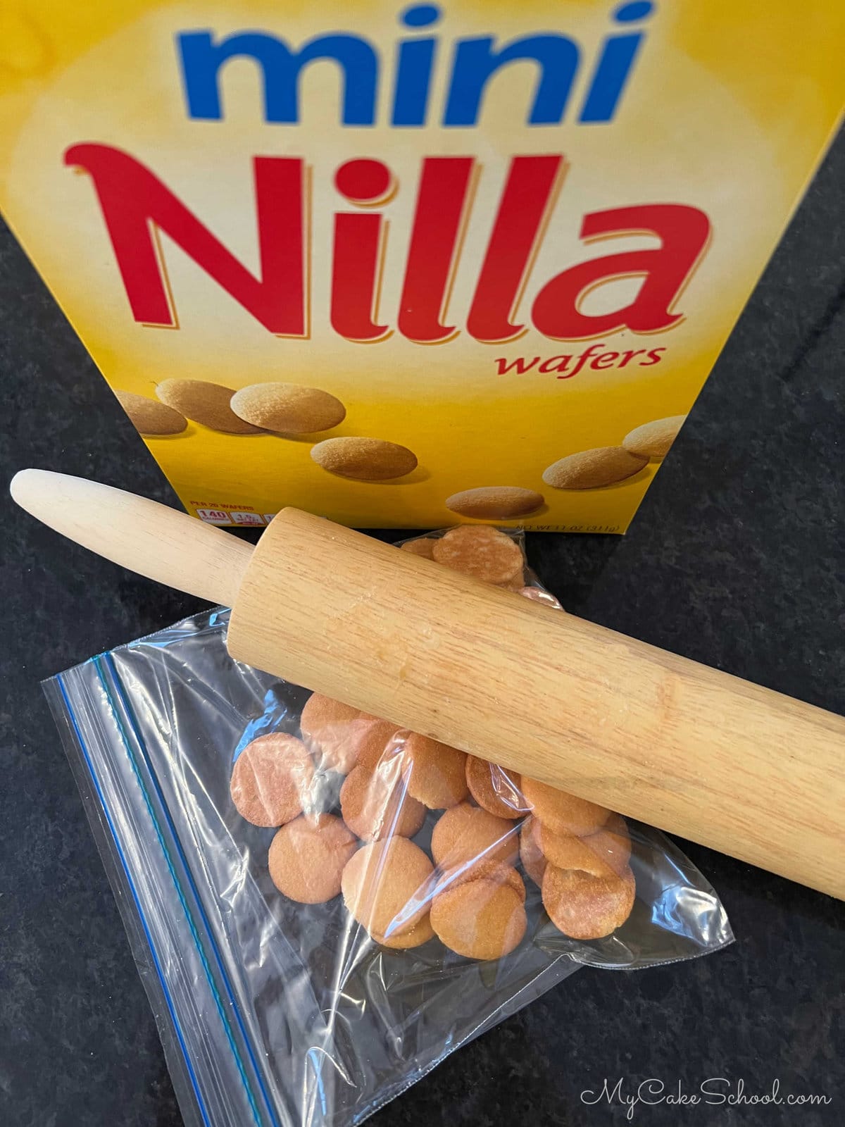 Sealed Mini Vanilla Wafers in a sealed ziplock bag with a rolling pin laying on top.