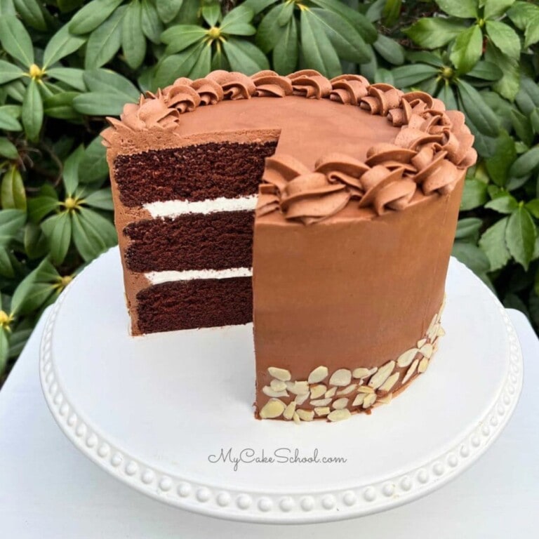 Sliced Chocolate Almond Cake on a pedestal.