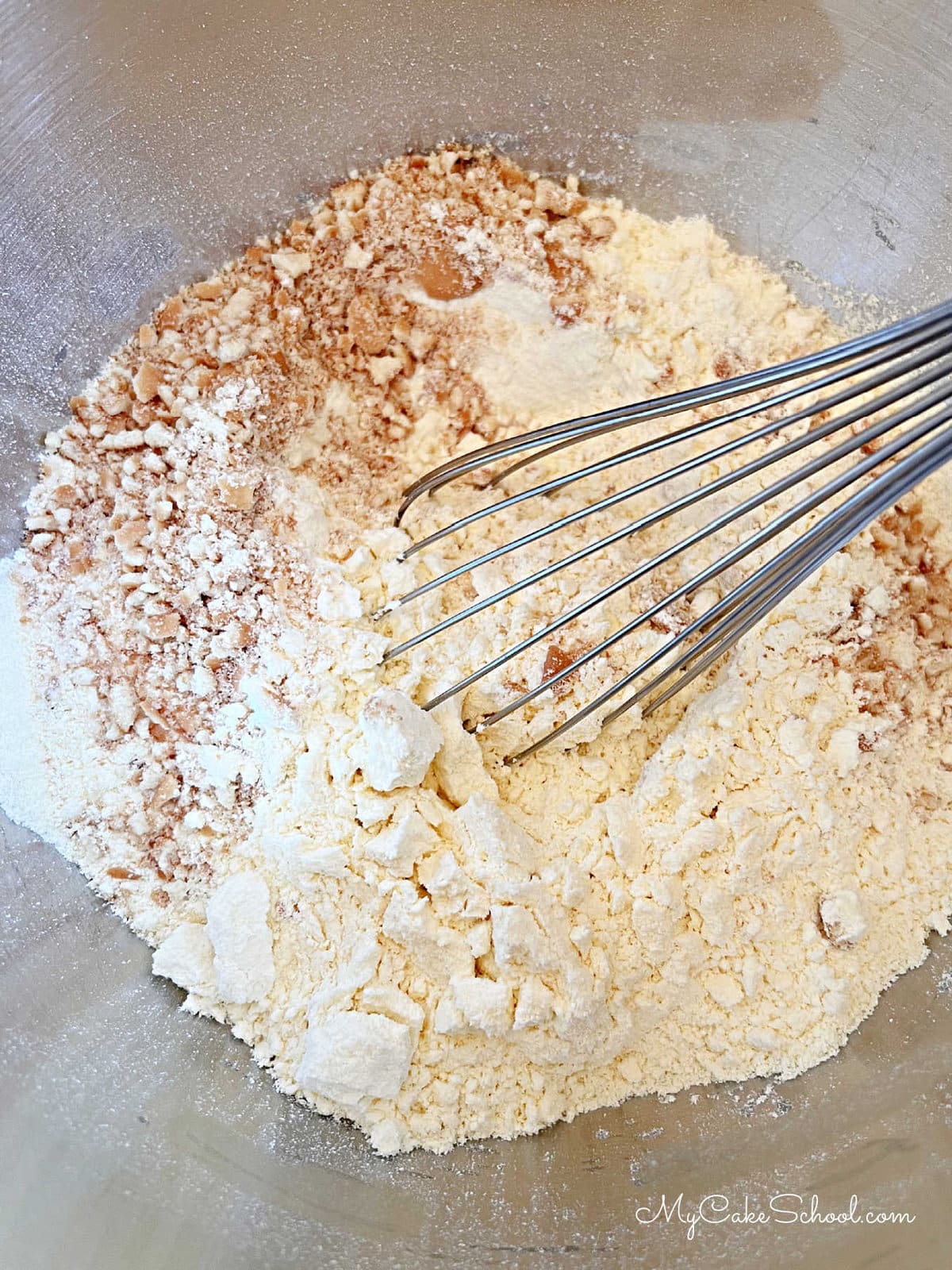 Bowl of dry ingredients with a whisk