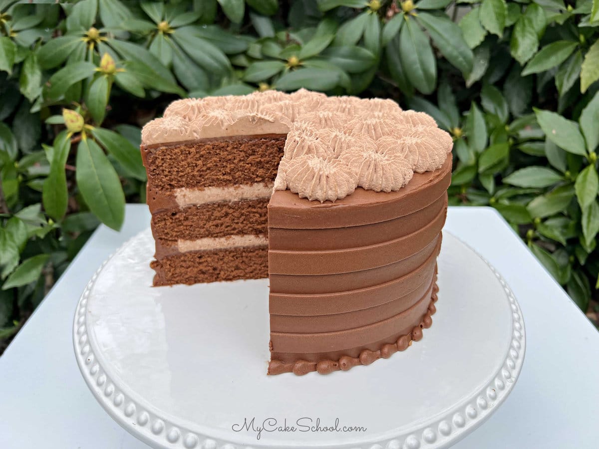 Chocolate Cake with slices removed, revealing the chocolate cream filling.