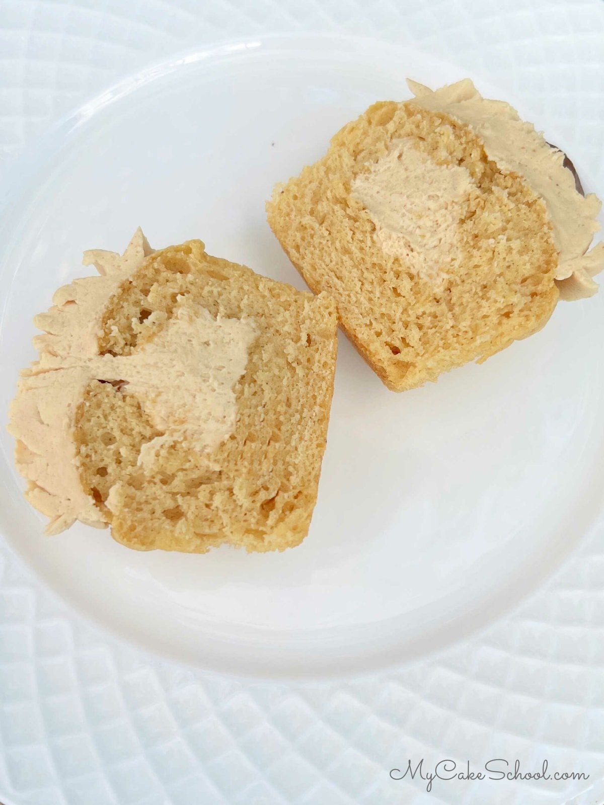 Filled Peanut Butter Cupcake on a plate, sliced in half