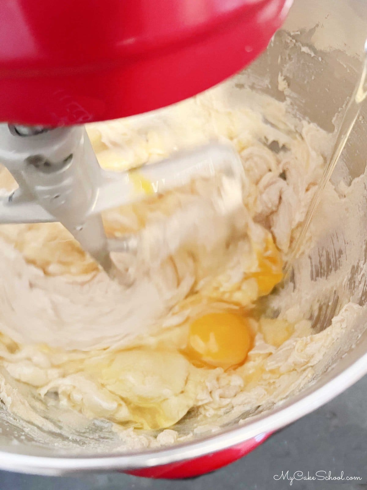 Adding Eggs to Cake Batter in Stand Mixer
