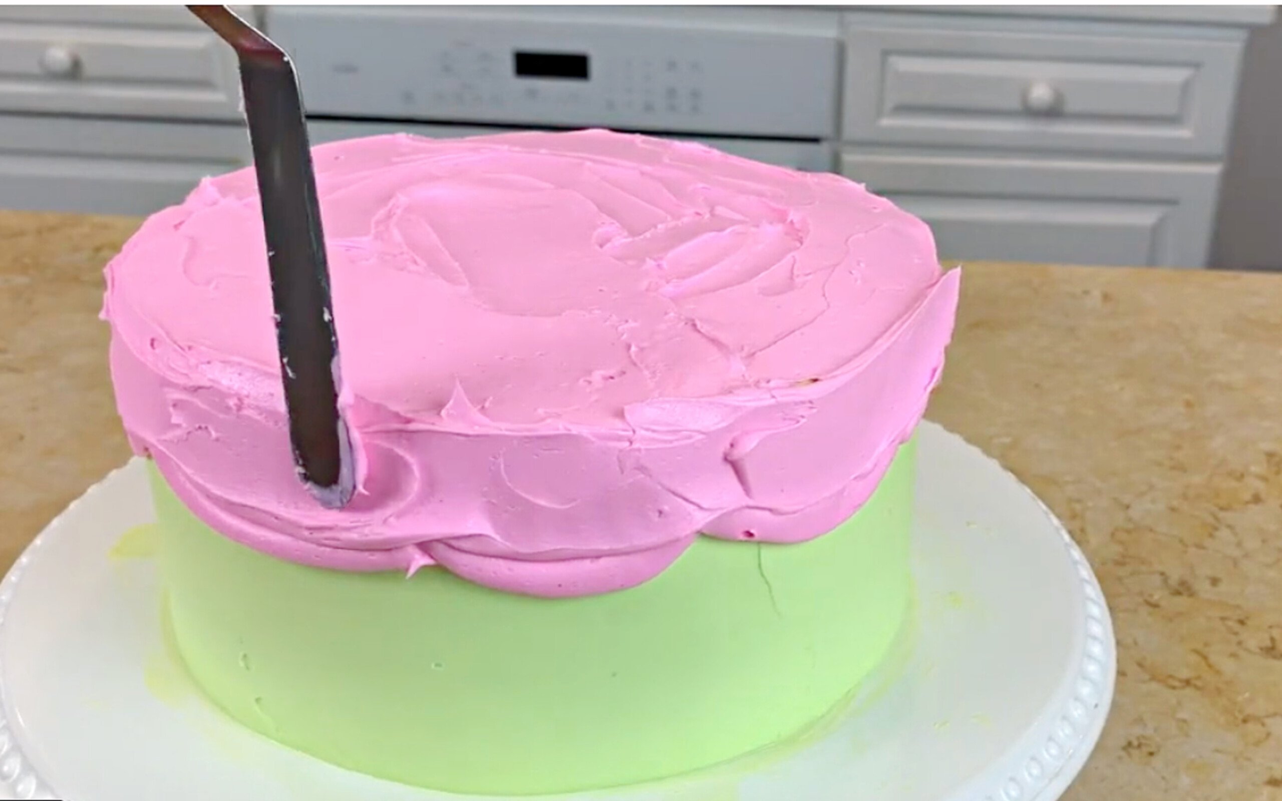 Smoothing the frosting on our buttercream cartoon cake.