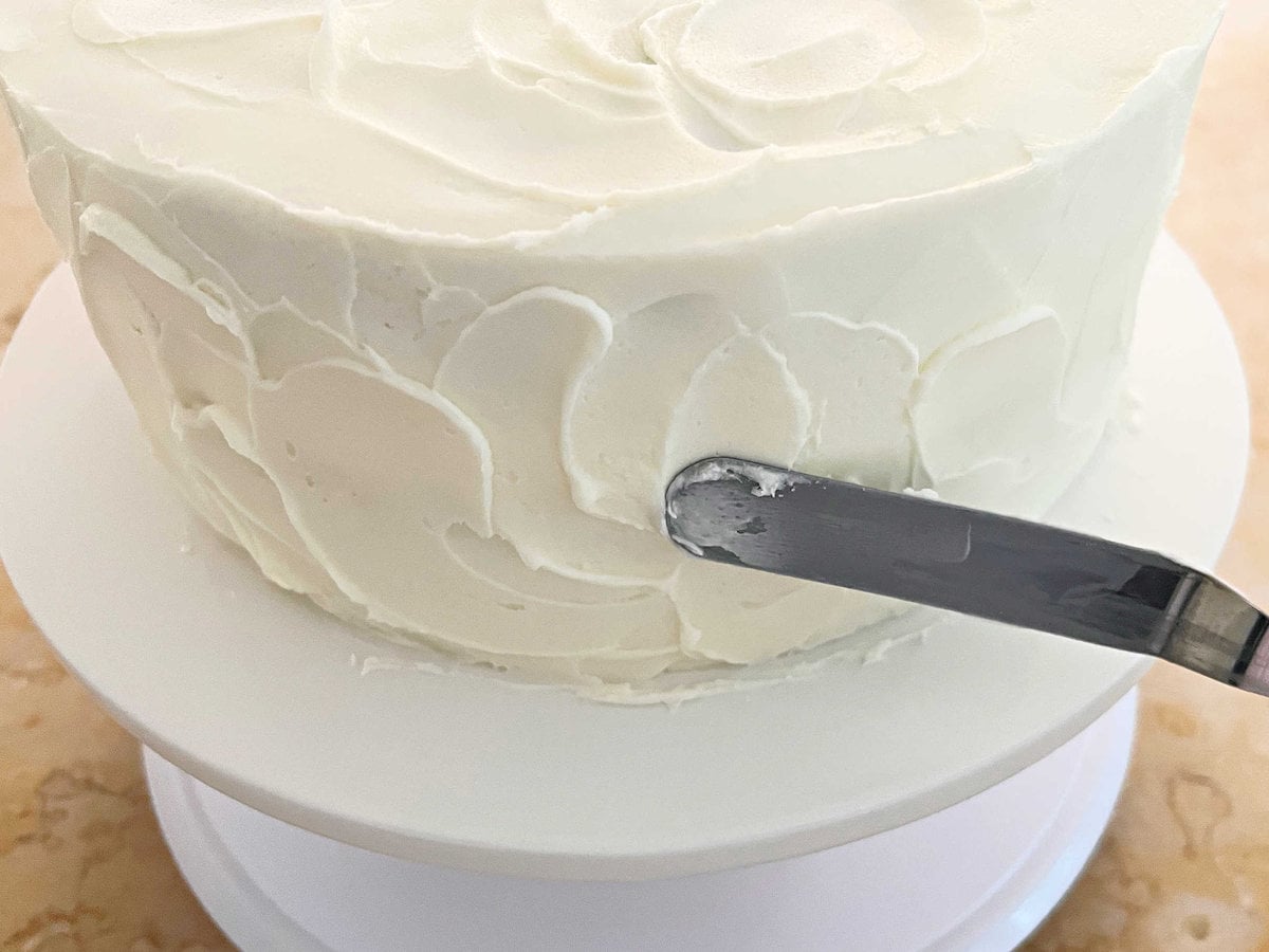 Texturing the frosted cake with a small offset spatula