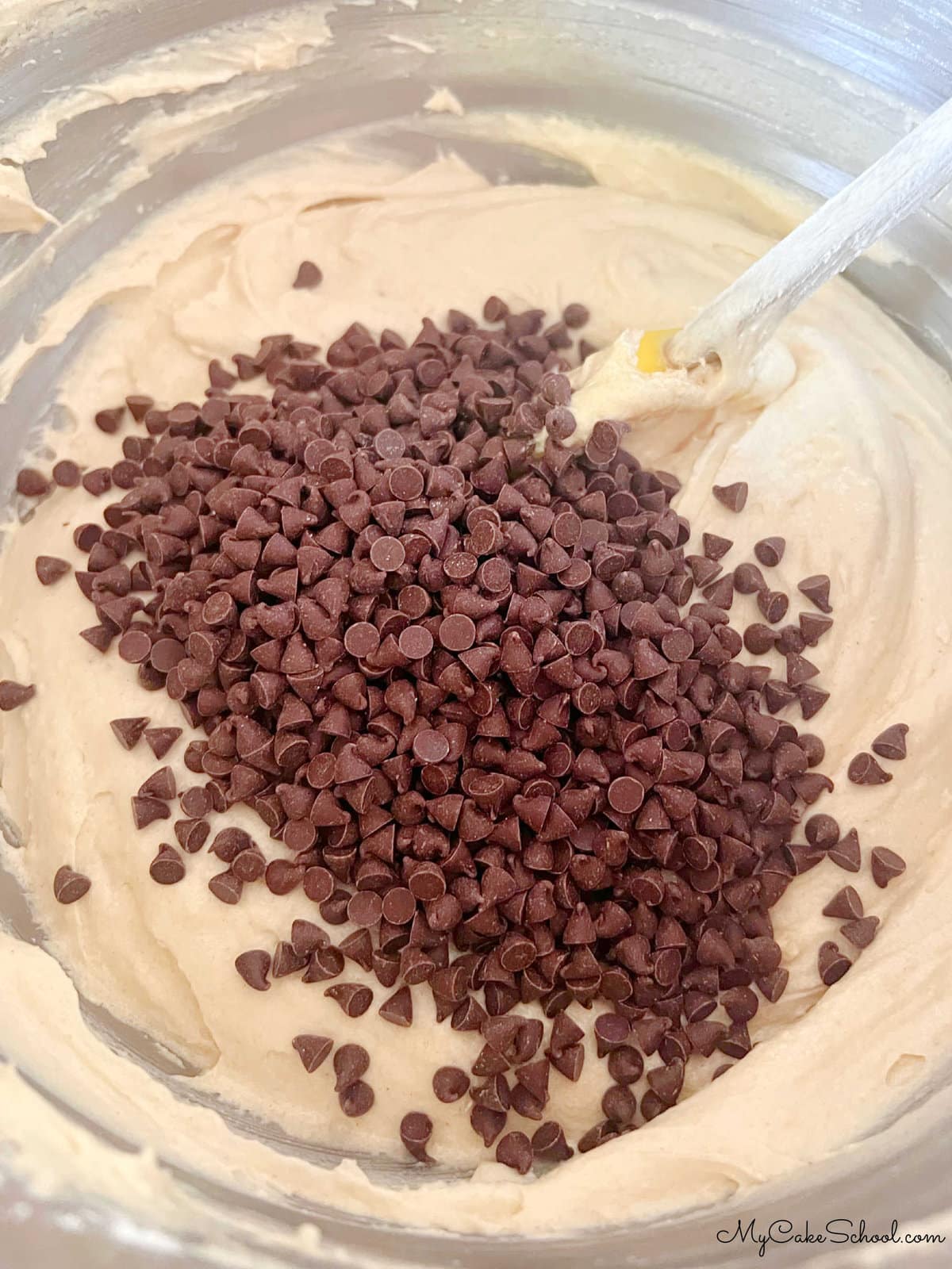 Bowl of Cake Batter with Mini Chocolate Chips on top, just before combining