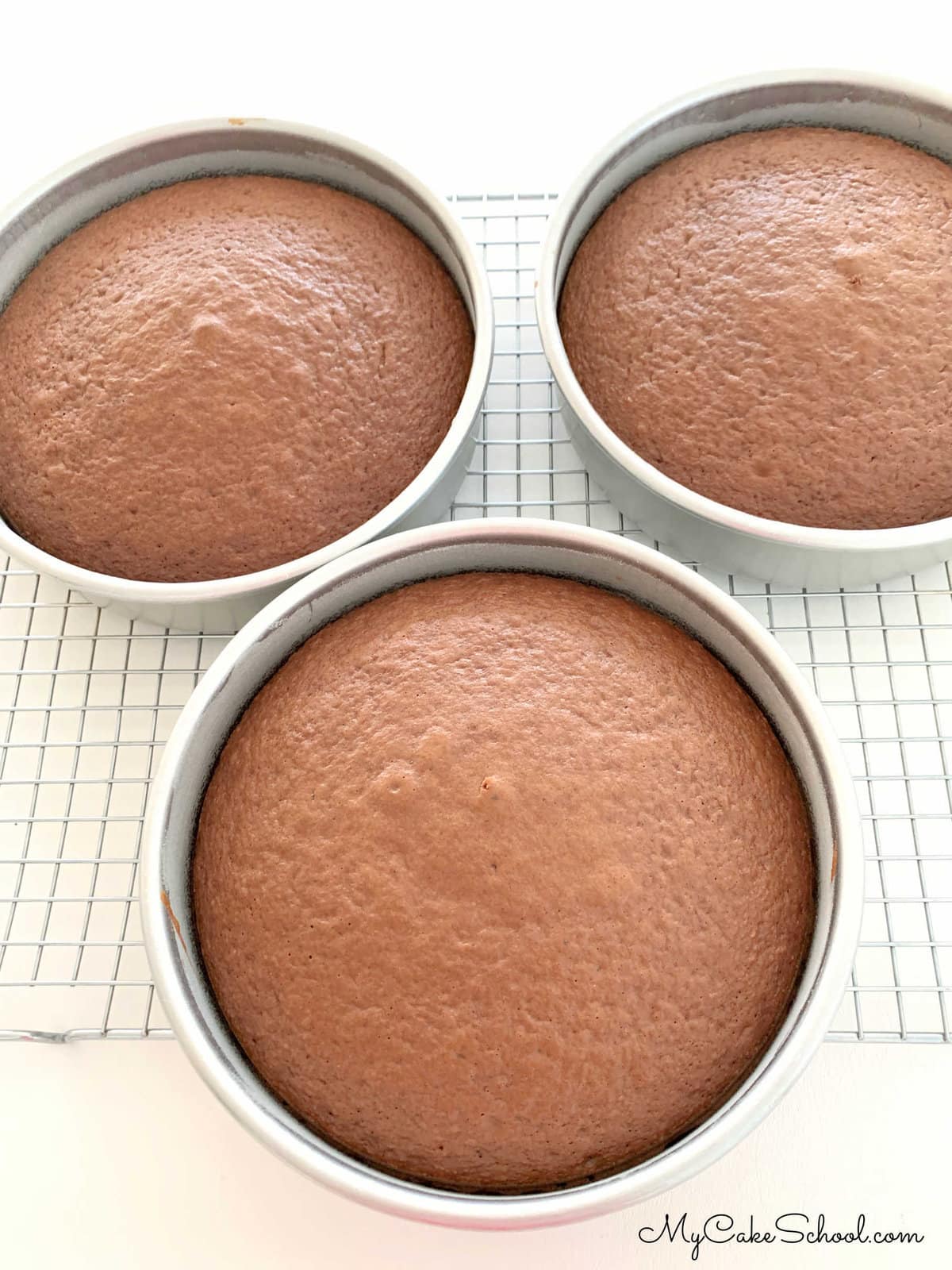 Three baked German Chocolate Cake Layers, cooling in pans