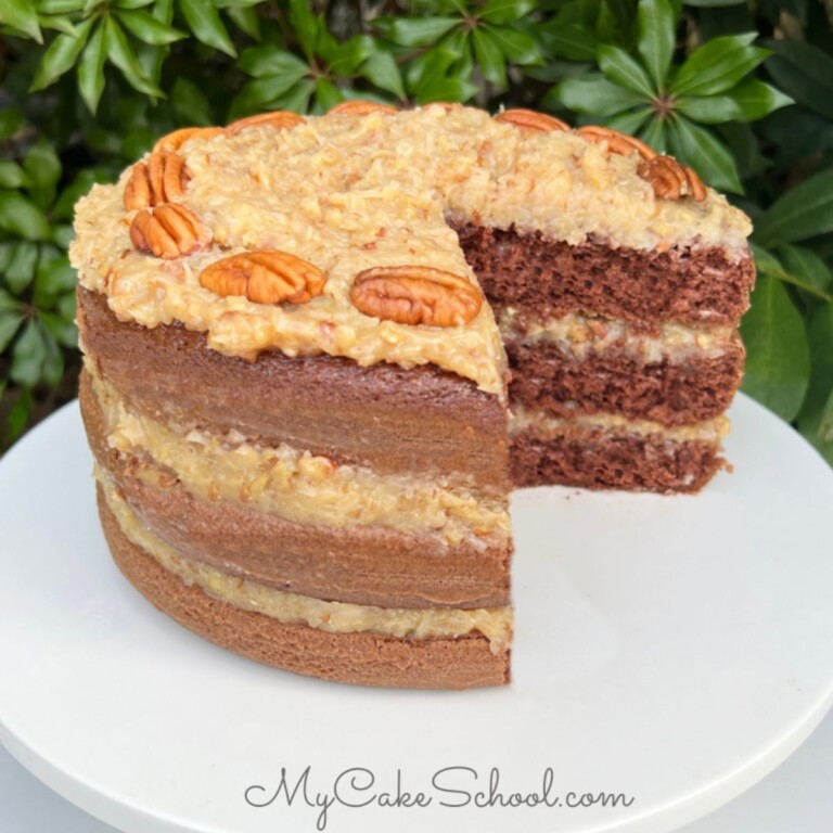 Photo of German Chocolate Cake on white cake pedestal.