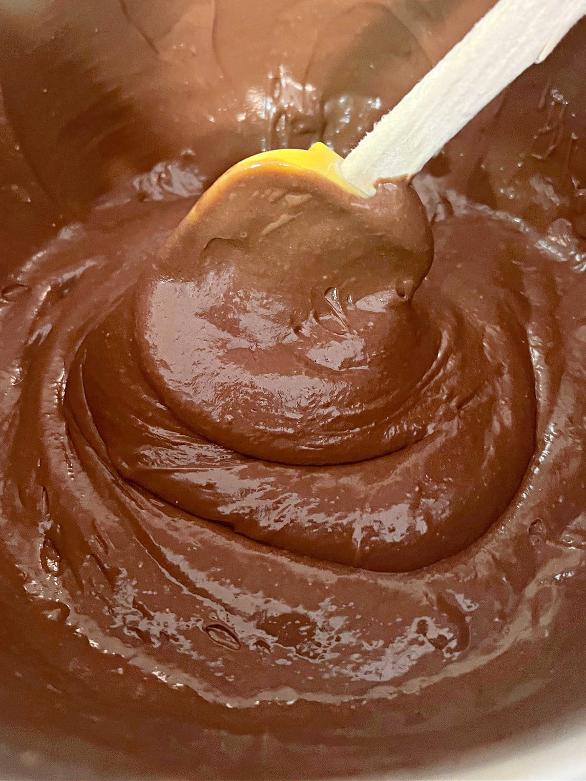 Bowl of mocha cake batter with spatula