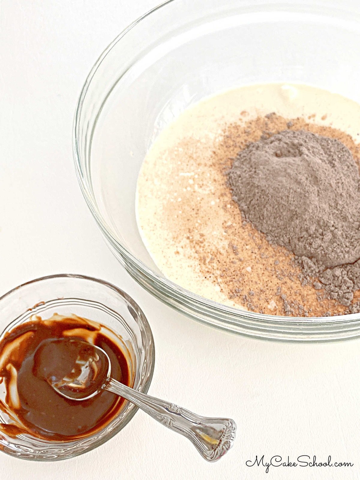 Small bowl of espresso mixture next to bowl of pudding and heavy cream mixture.