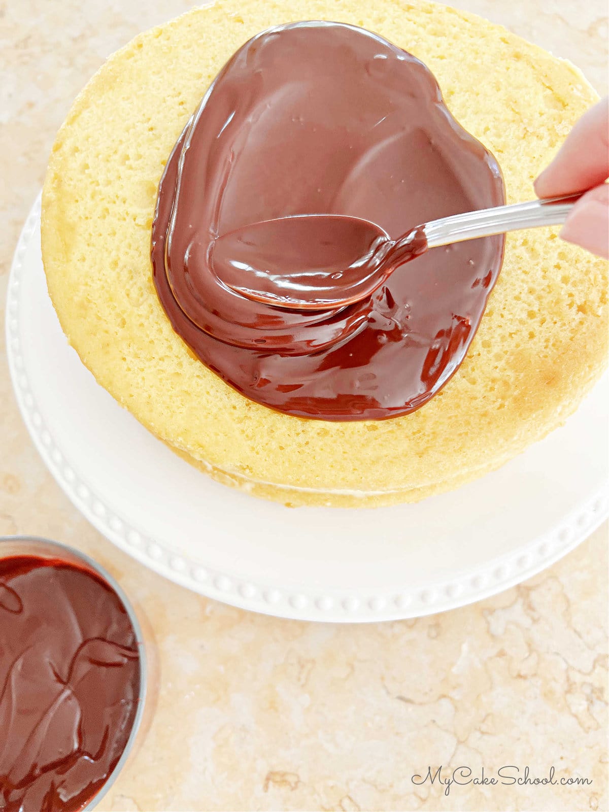 Applying ganache to the top of the cake