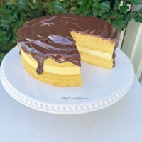 Boston Cream Pie from Cake Mix on a white pedestal