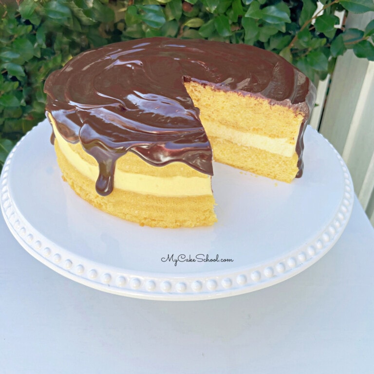 Boston Cream Pie from Cake Mix on a white pedestal