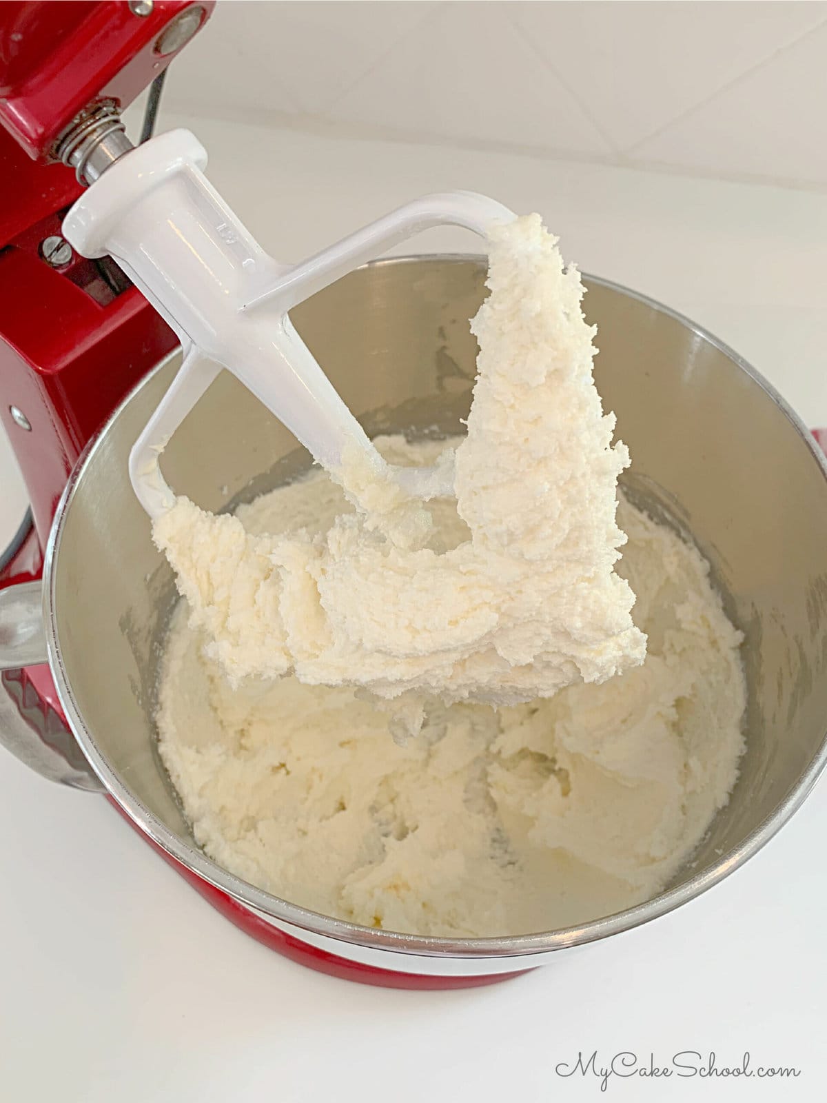Butter and sugar mixture in mixing bowl with paddle attachment