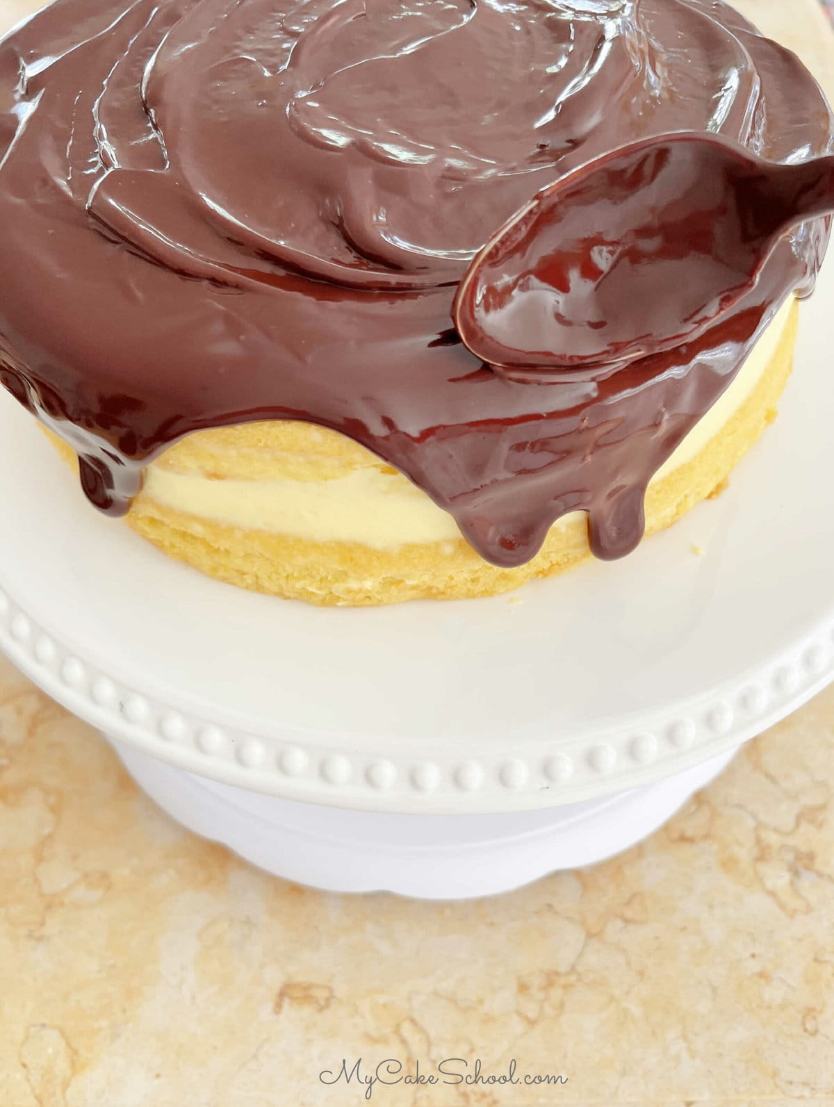 Spreading ganache on top of the cake