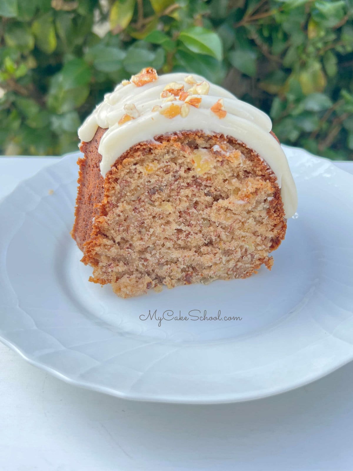 Slice of Hummingbird Bundt Cake on a white plate