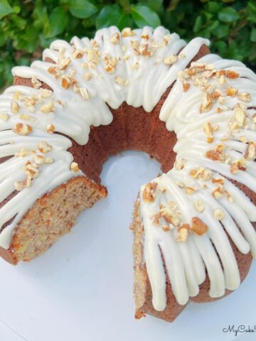 Sliced Hummingbird Bundt Cake on a white pedestal