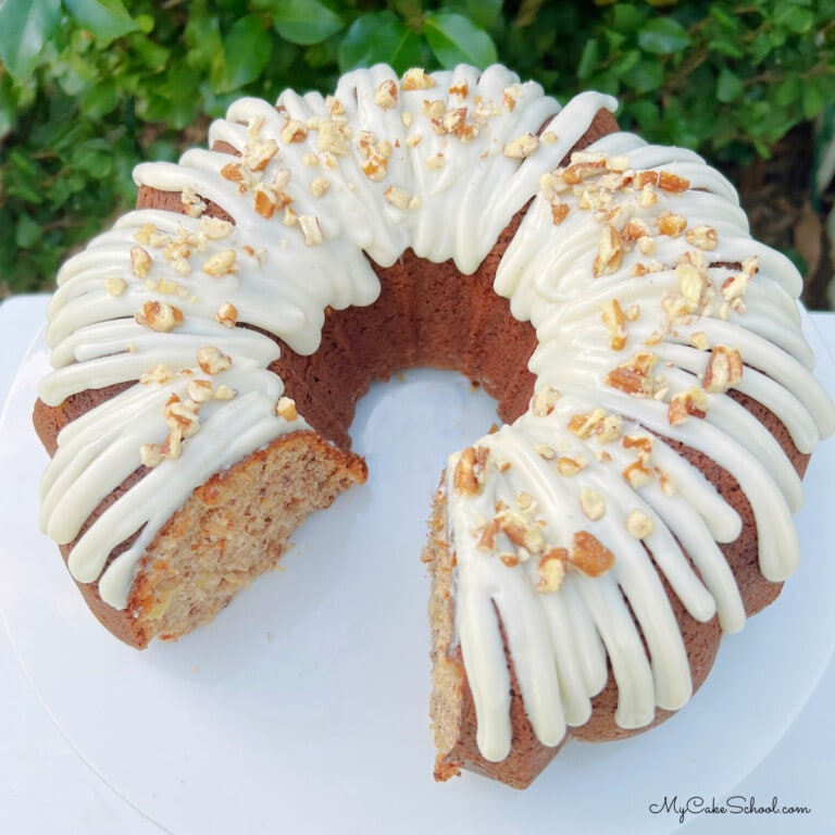 Sliced Hummingbird Bundt Cake on a white pedestal