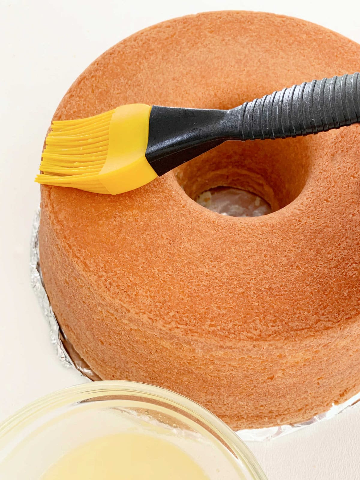 Applying Lemon Simple Syrup to Cake with Pastry Brush