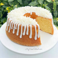 Sliced Lemon Coconut Pound Cake on pedestal