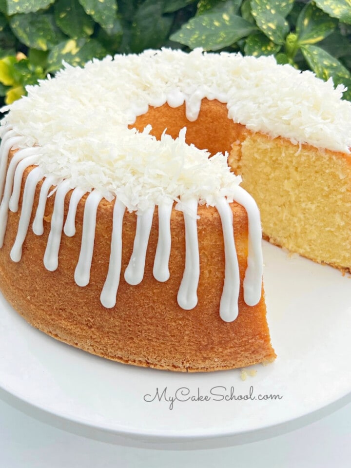 Sliced Lemon Coconut Pound Cake on pedestal