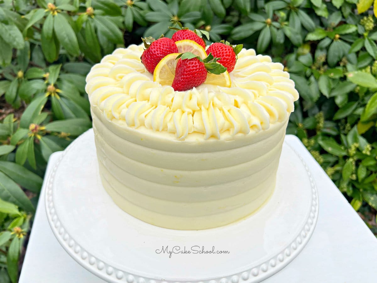 Decorated Strawberry Lemonade Cake on White Pedestal