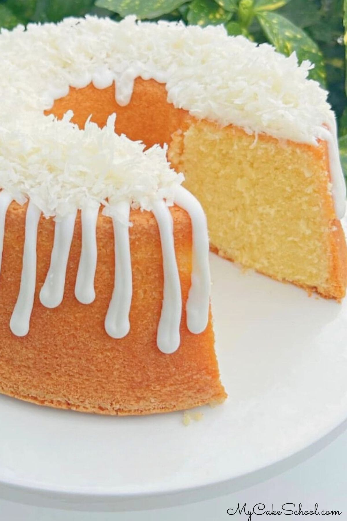 Sliced Lemon Coconut Pound Cake on a pedestal.