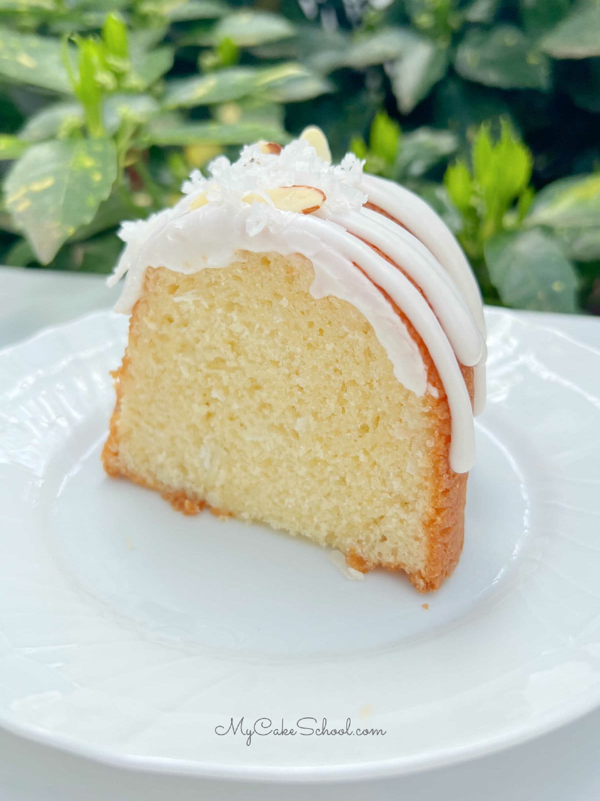 Slice of Almond Coconut Bundt Cake on a white plate