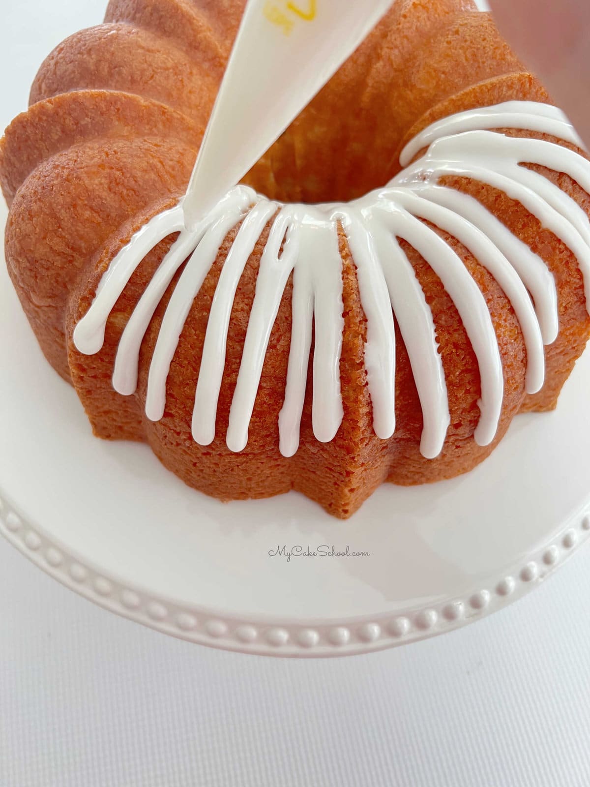 Applying the glaze to our Almond Coconut Bundt Cake