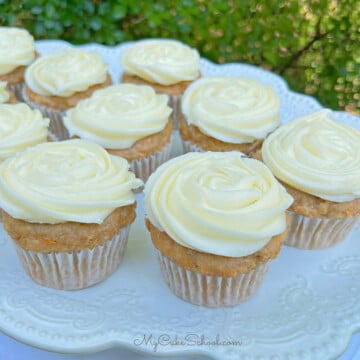 Platter of carrot cupcakes, swirled with cream cheese frosting