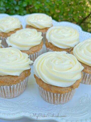 Platter of carrot cupcakes, swirled with cream cheese frosting