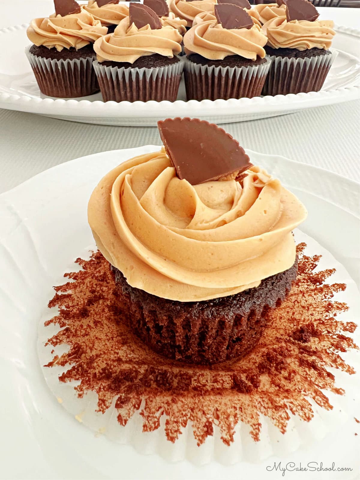 Closeup of Unwrapped, Frosted Chocolate Peanut Butter Cupcake.