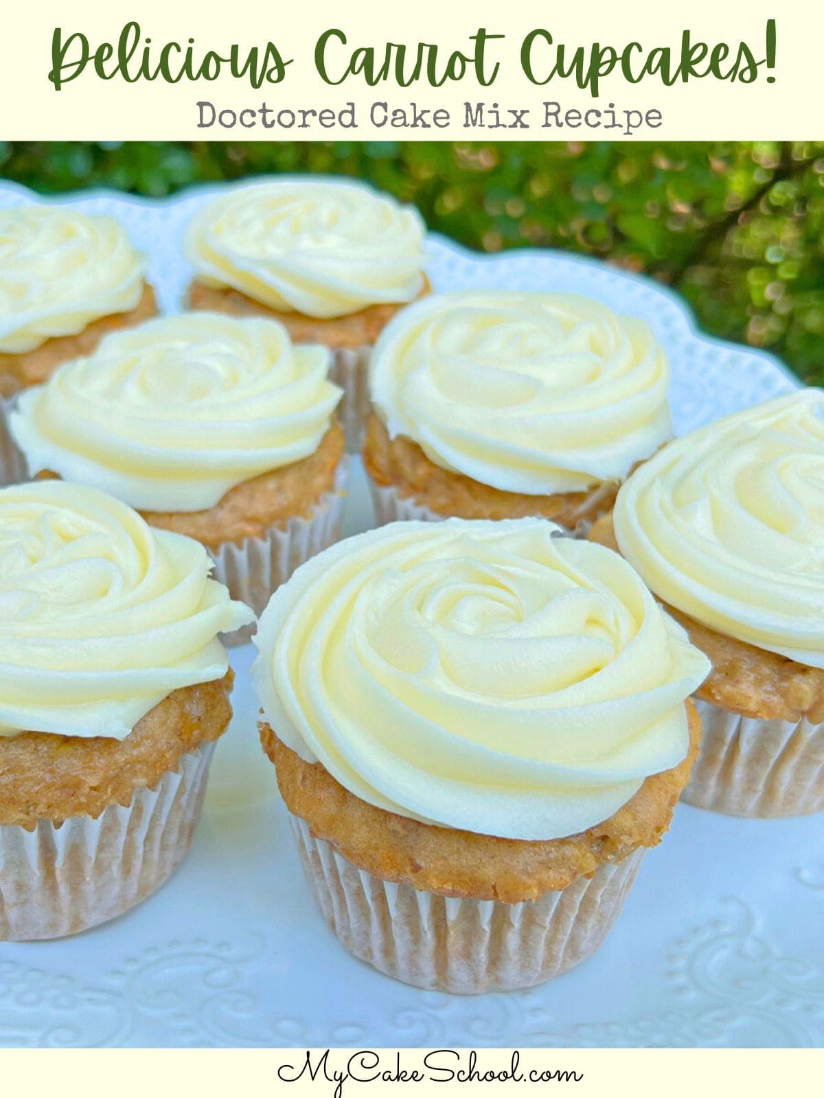 Platter of carrot cupcakes, swirled with cream cheese frosting