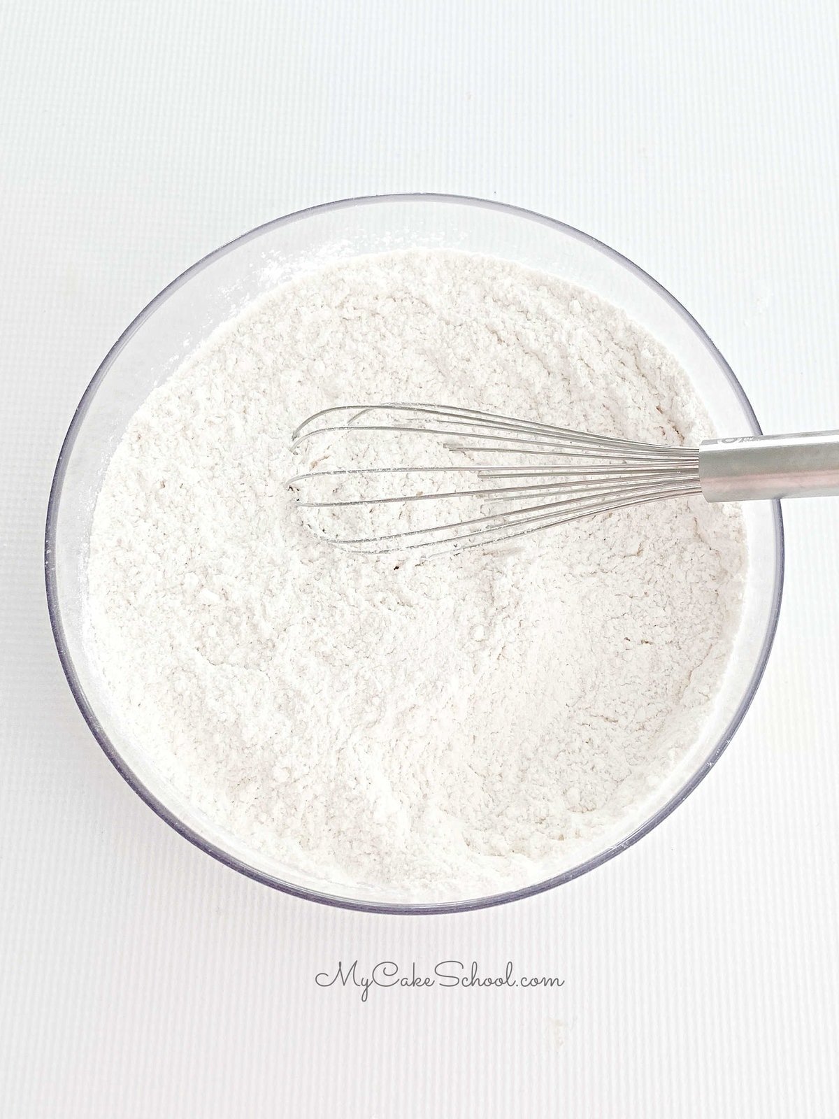 Bowl of dry ingredients with whisk