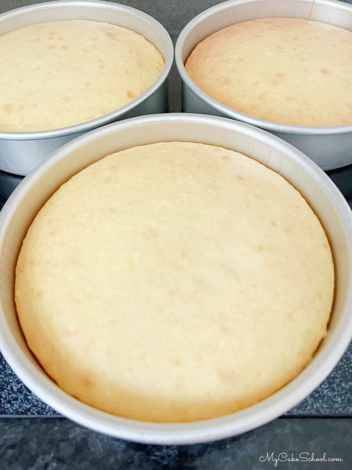 Three lemon cream cake layers fresh from the oven.