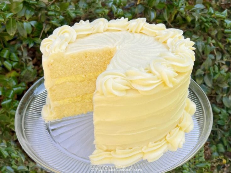 Sliced Lemon Cream Cake on a pedestal