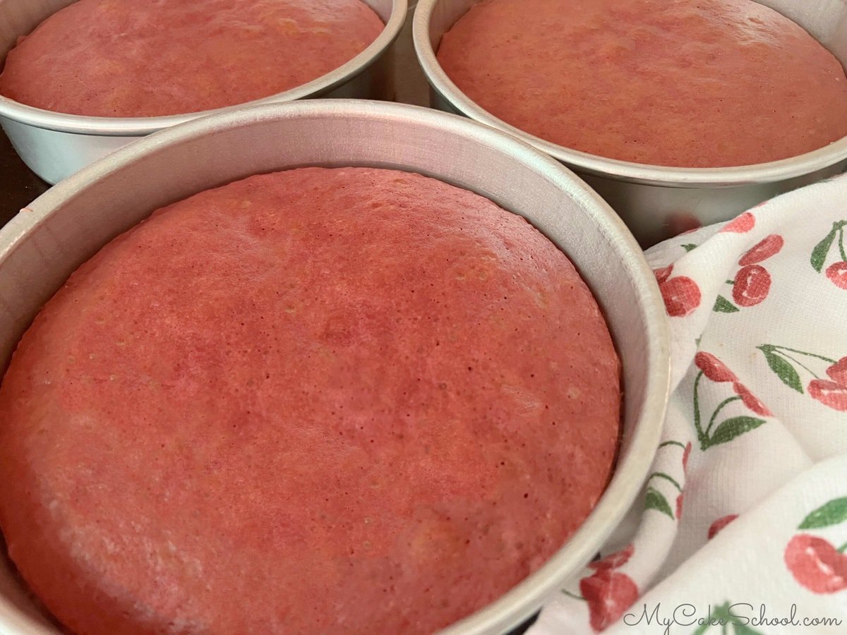 Freshly baked raspberry cake layers, still in pans