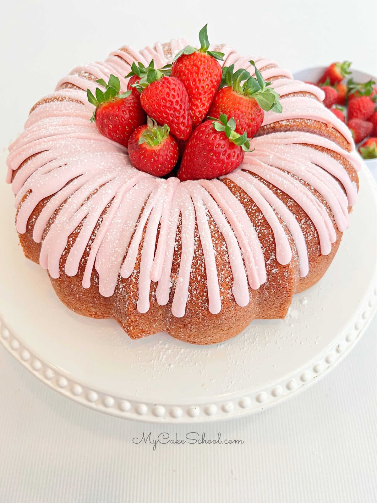 Strawberry Bundt Cake topped with simple strawberry glaze and fresh strawberries