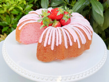 Sliced Strawberry Bundt Cake on a white pedestal