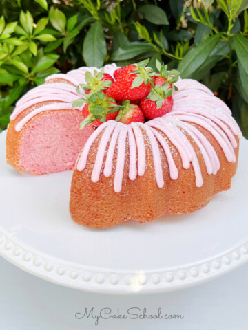 Sliced Strawberry Bundt Cake on a white pedestal