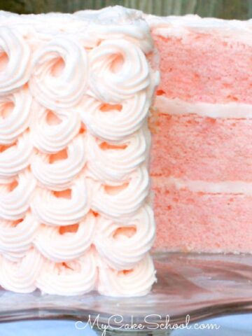 Sliced Pink Champagne Layer Cake on pedestal