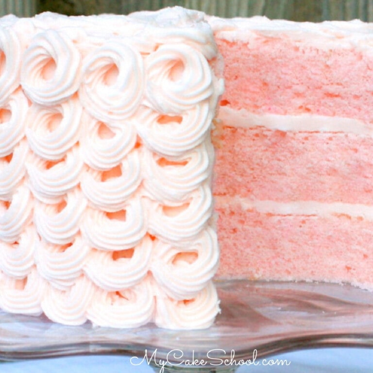 Sliced Pink Champagne Layer Cake on pedestal