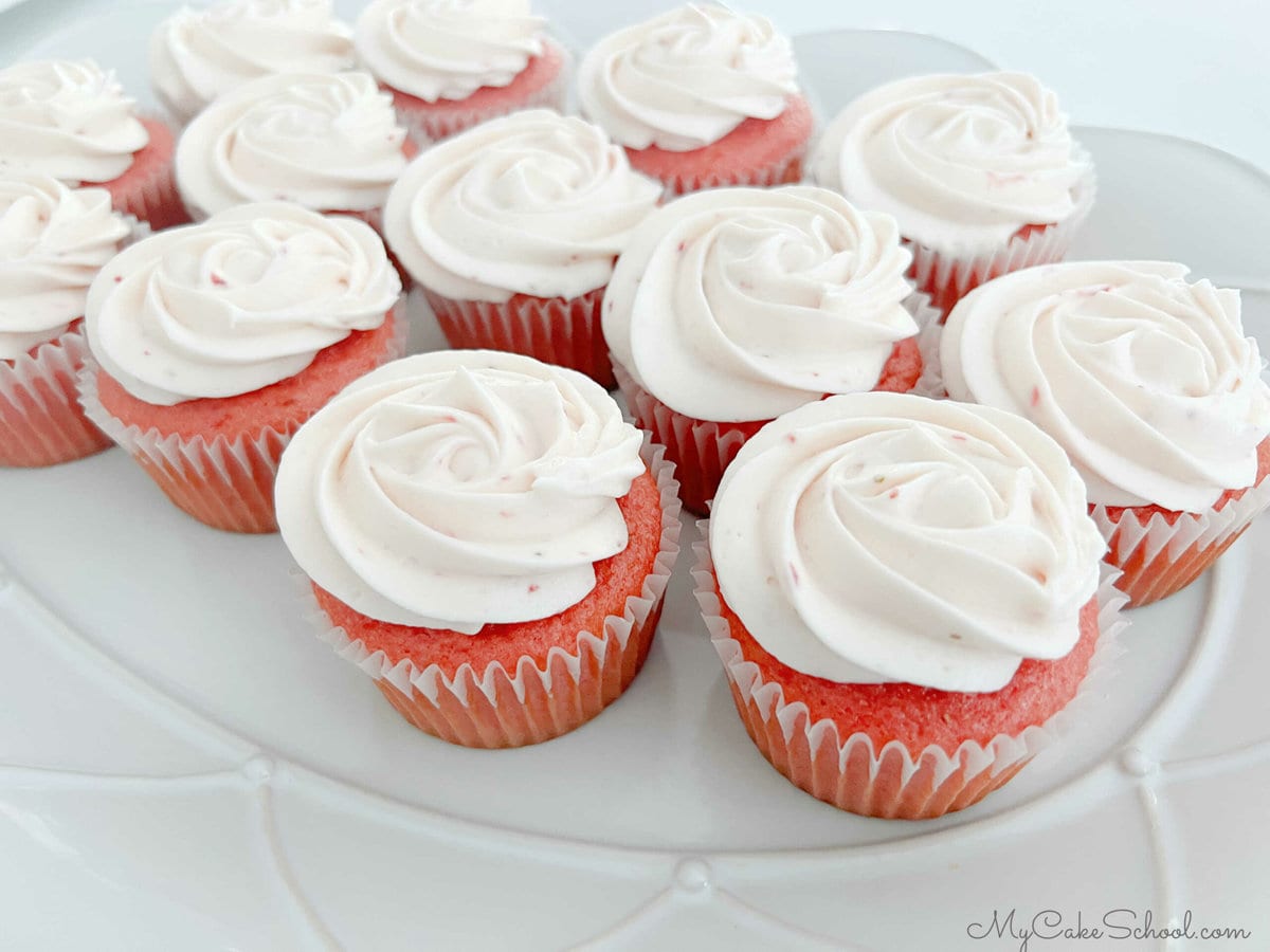 Platter of frosted strawberry cupcakes